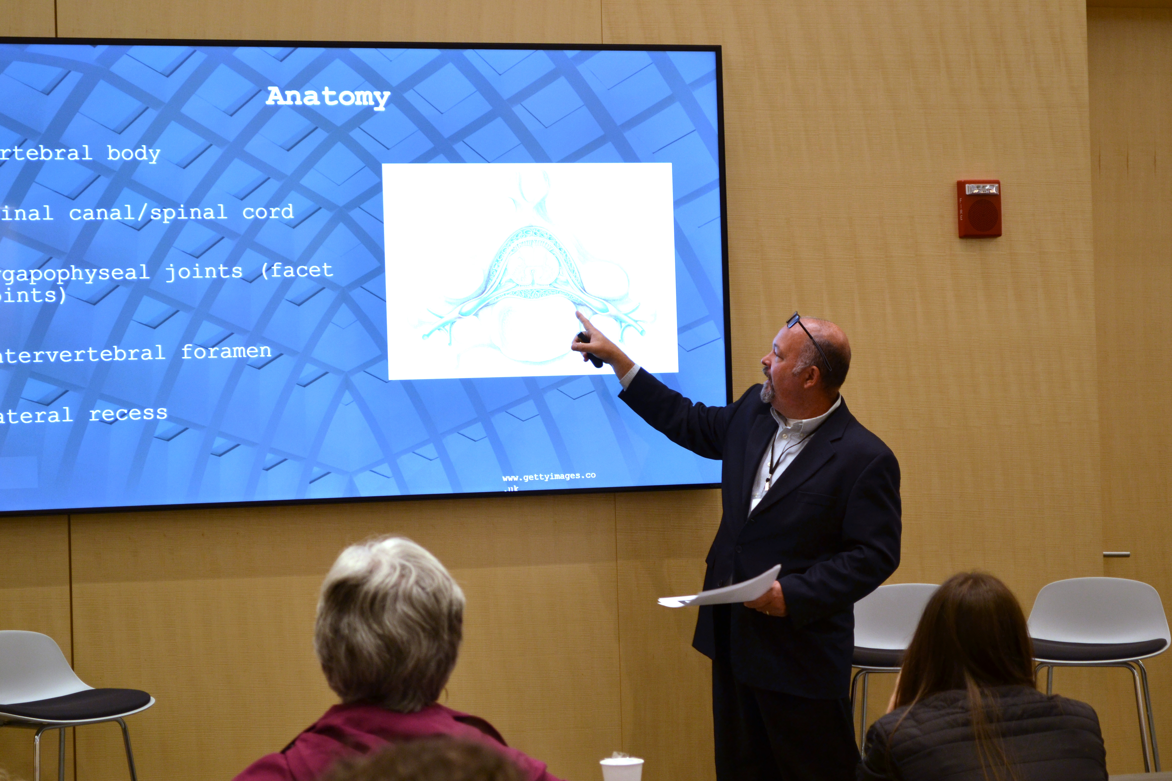 Man pointing at screen and instructing group