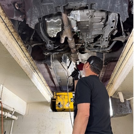 A Chula Vista police officer etches a vehicle’s catalytic converter during an etching event on May 17, 2025, in San Diego.