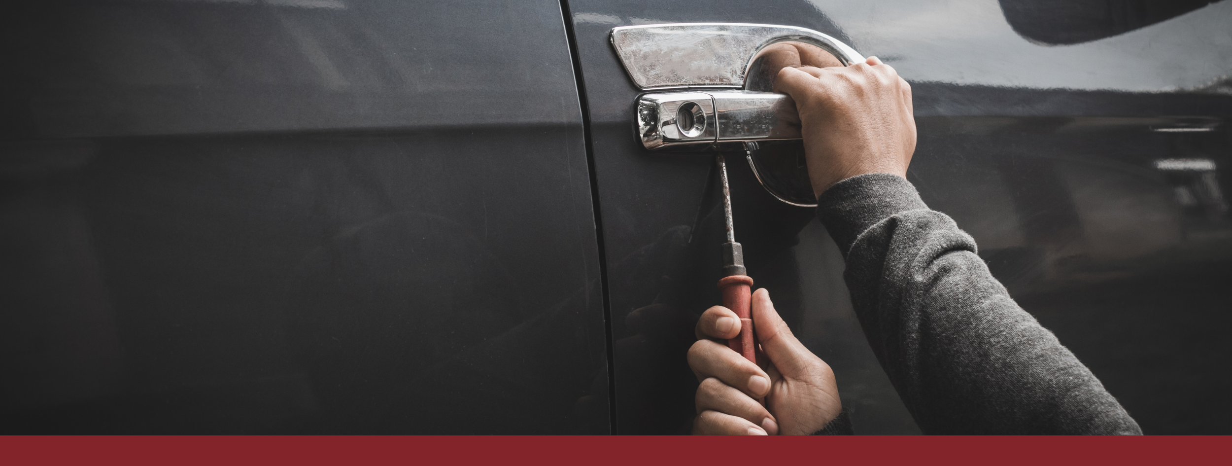 Banner with man breaking into car with screwdriver 